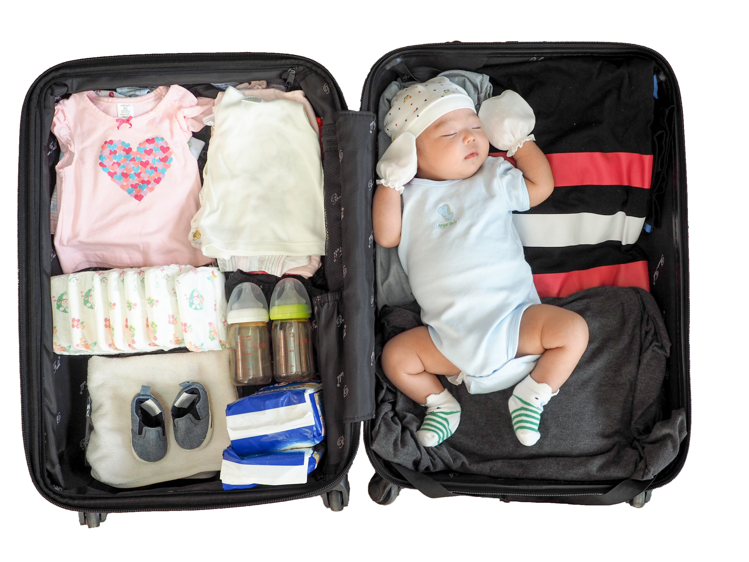 The child is sleeping in a suitcase on white background .