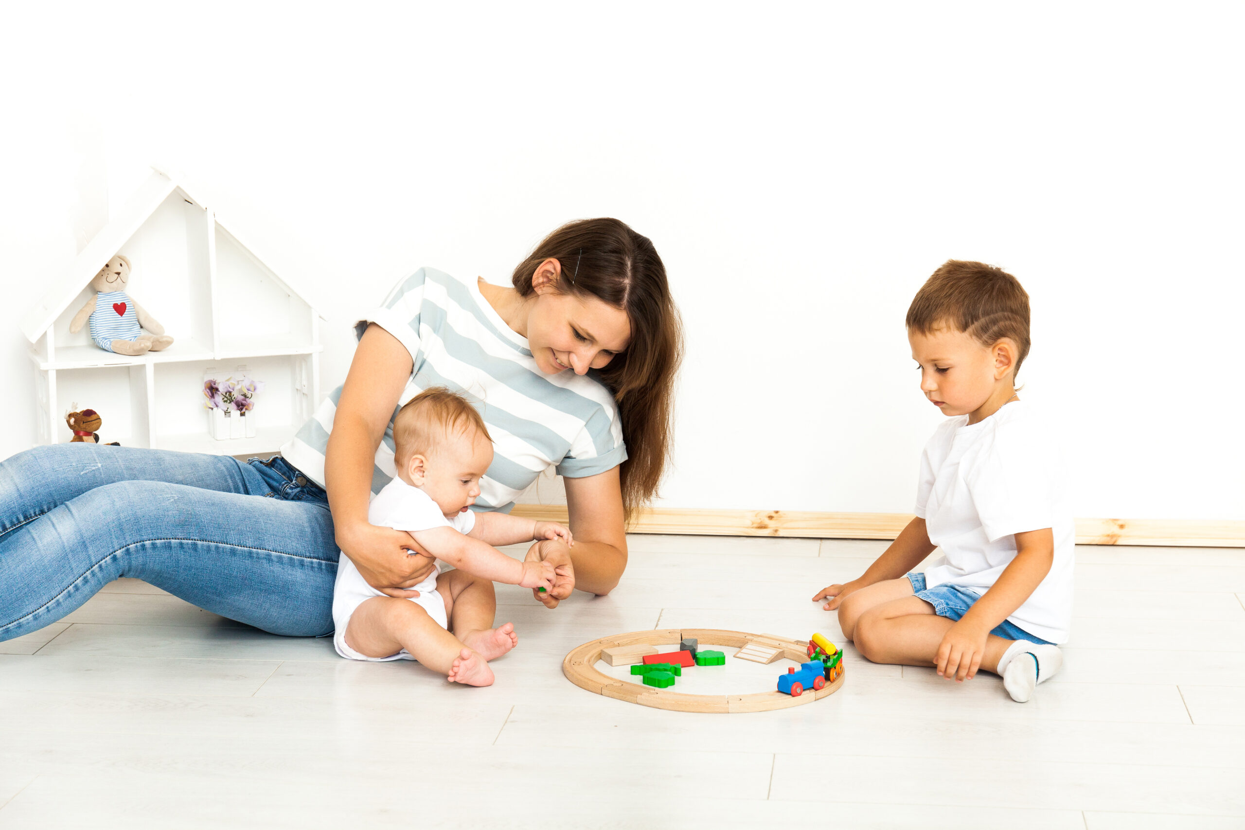 Mother Sitting With kids playing game Indoors